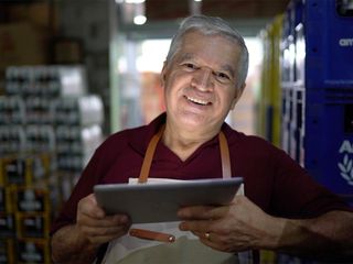 Man holding a tablet and working at a warehouse